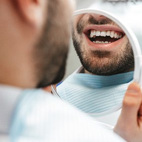 Patient looking at smile in reflection
