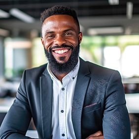 a smiling businessman sitting in an office