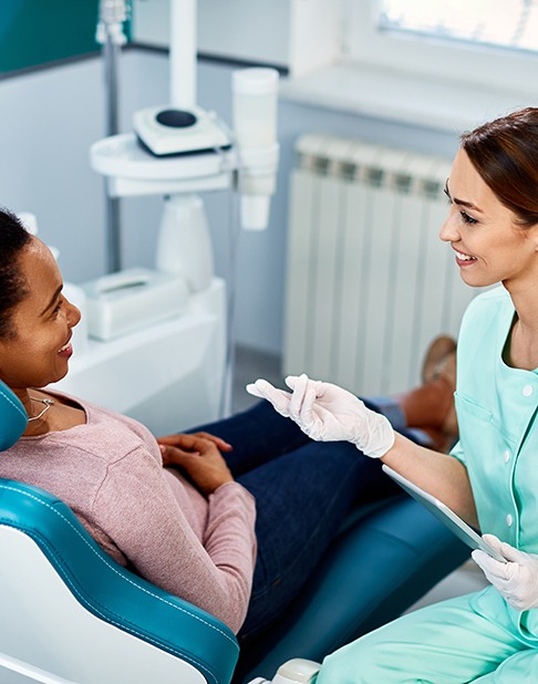Dentist discussing treatment options with patient in dental chair