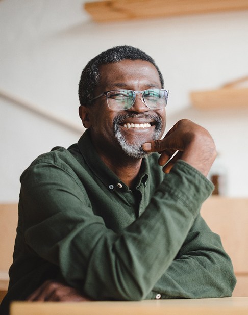 Man in green shirt smiling