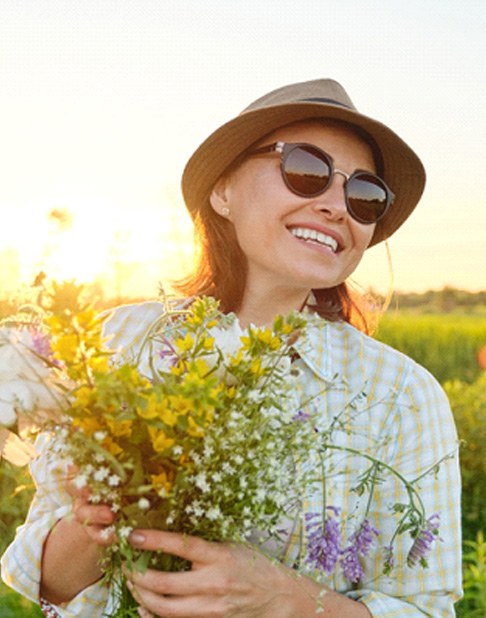 smiling woman with dental bridge in New York