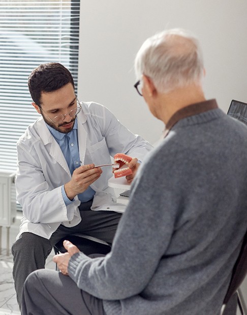Older man learning about oral hygiene