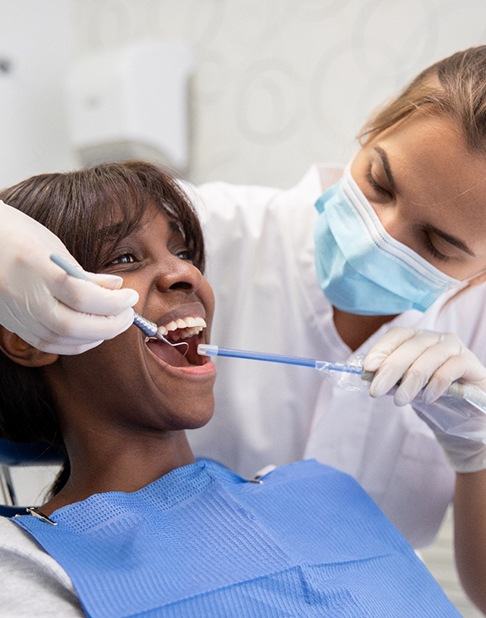 Dentist cleaning a patient’s teeth
