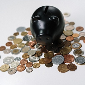 Black piggy bank and coins
