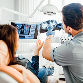 a dentist showing a patient her X-ray