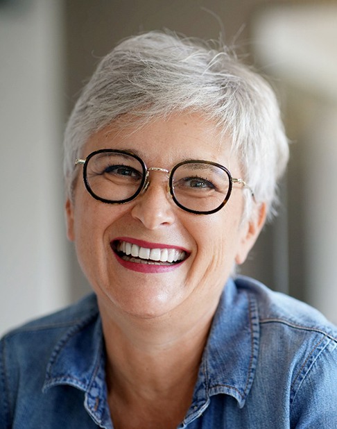 a mature woman smiling with dentures in New York