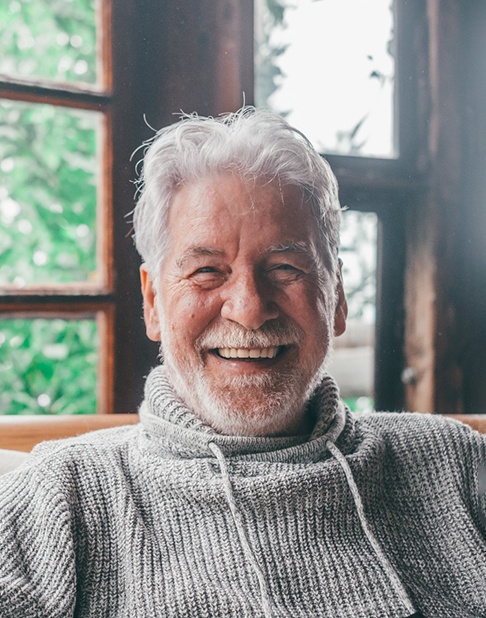 a mature man smiling with dentures in New York 