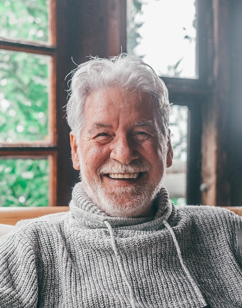 a mature man smiling with dentures in New York