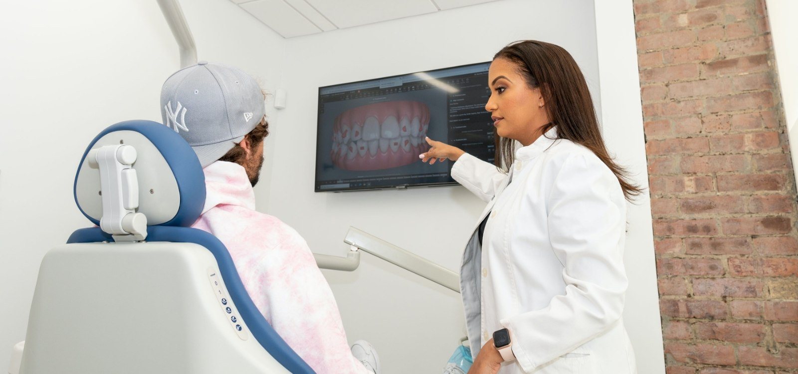 New York City dentist and patient looking at digital x-rays