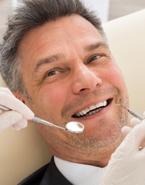 Man smiling at dentist in New York