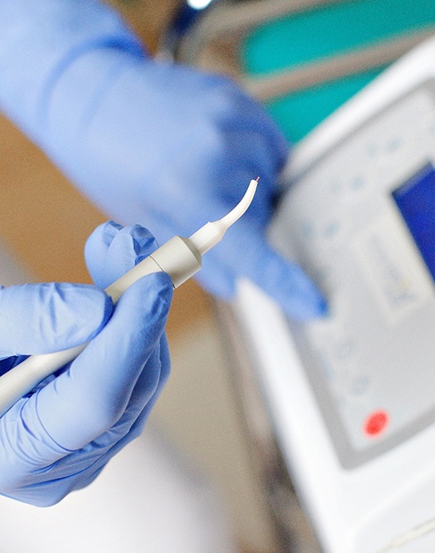 a dental holding a dental laser