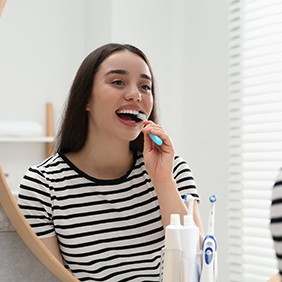 a woman brushing her teeth