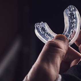 a person holding a mouthguard