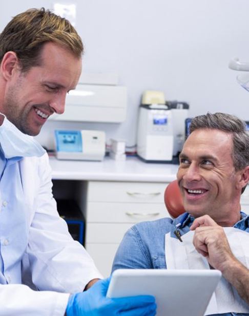 Dentist and patient consulting in the treatment room