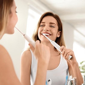 a patient carefully brushing their teeth