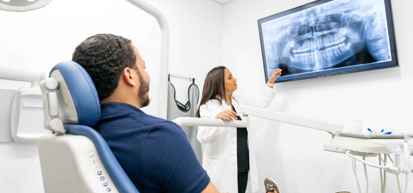 New York City dentist Francisca Sanchez D D S showing dental X rays to a patient