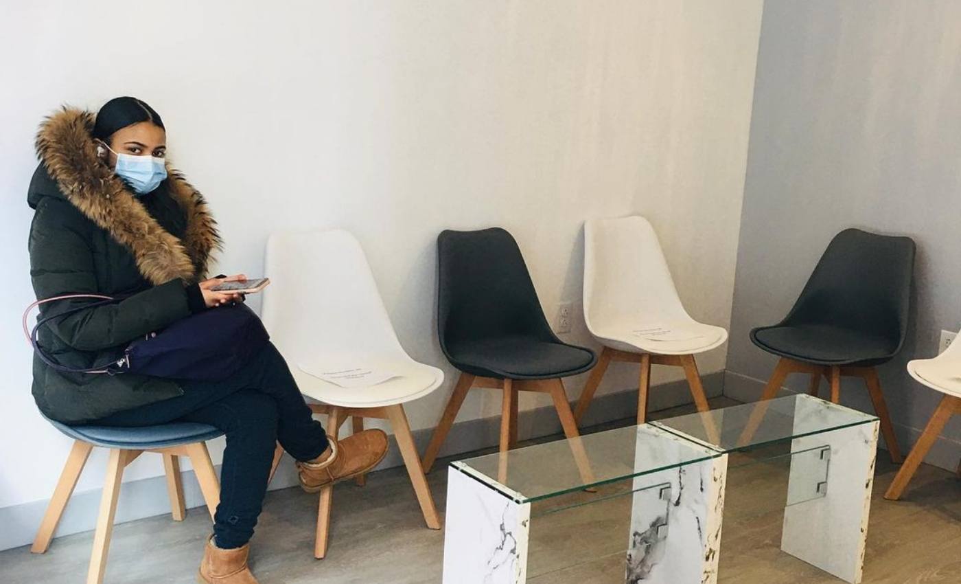 Woman sitting in waiting room of New York City dental office