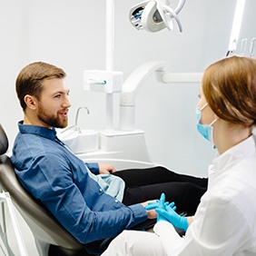 Dentist and patient having a friendly conversation