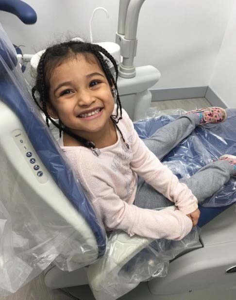 Young patient smiling after receiving dental sealants