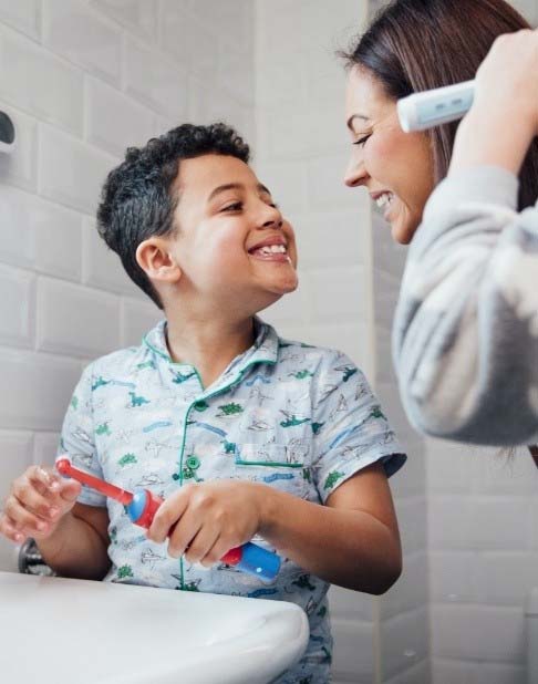 Mother and child brushing teeth during at home hygiene 