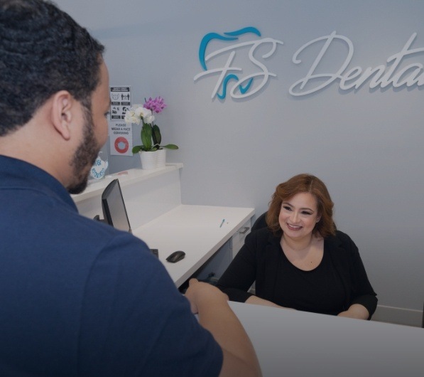 Patient checking in at dental office for gum disease treatment