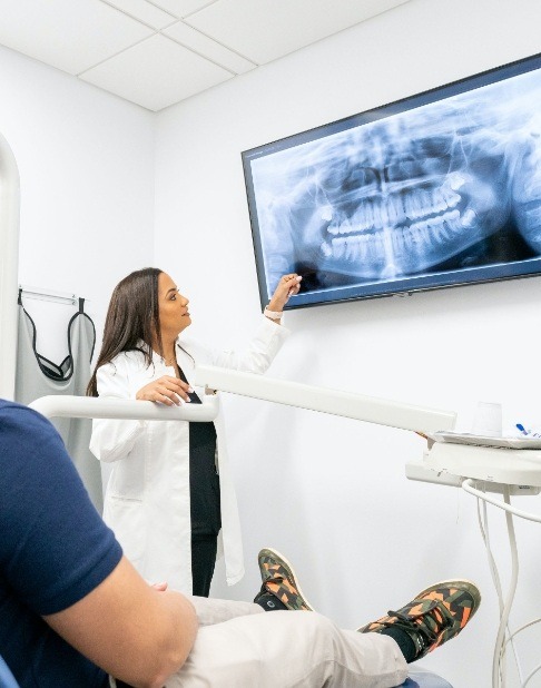 Dentist and patient looking at digital x-rays