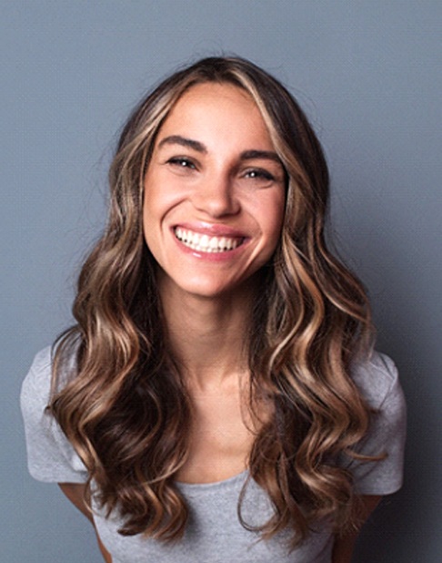 woman smiling after getting veneers in New York