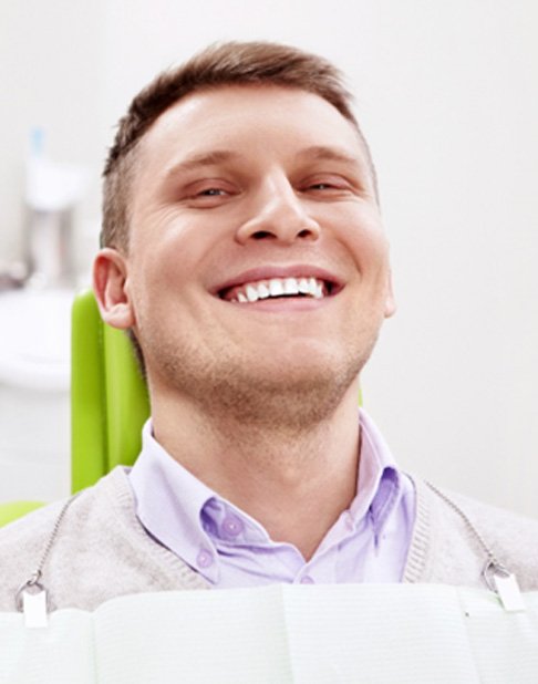 Man in dental chair for teeth whitening in New York City, NY