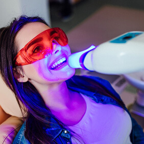 woman getting in-office whitening treatment