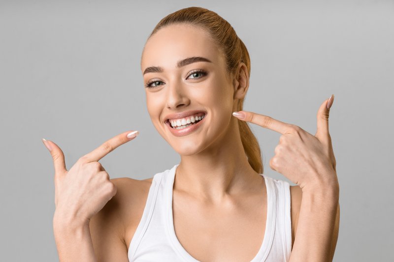 woman pointing to perfect white smile