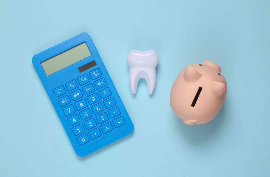 Calculator, tooth, and piggy bank